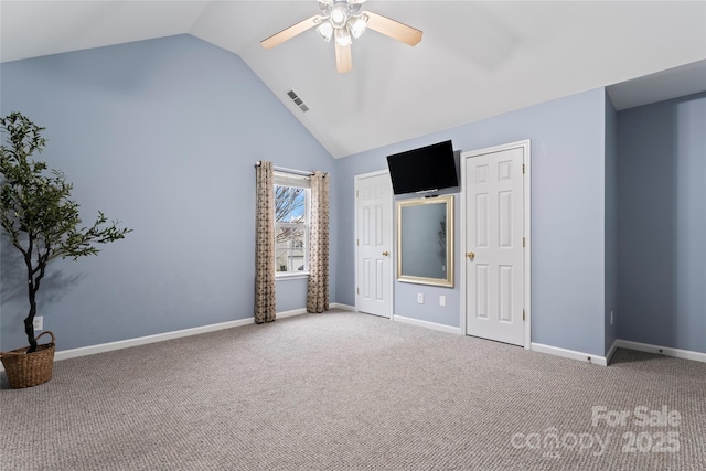 unfurnished bedroom with ceiling fan, vaulted ceiling, and carpet