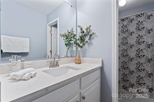 bathroom featuring vanity and curtained shower