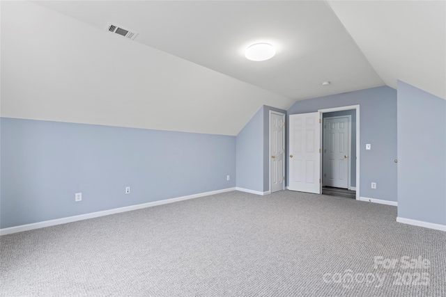 additional living space featuring lofted ceiling and carpet floors