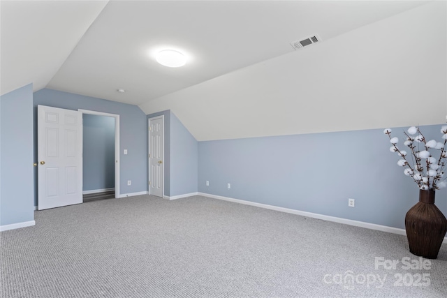 additional living space with lofted ceiling and carpet flooring