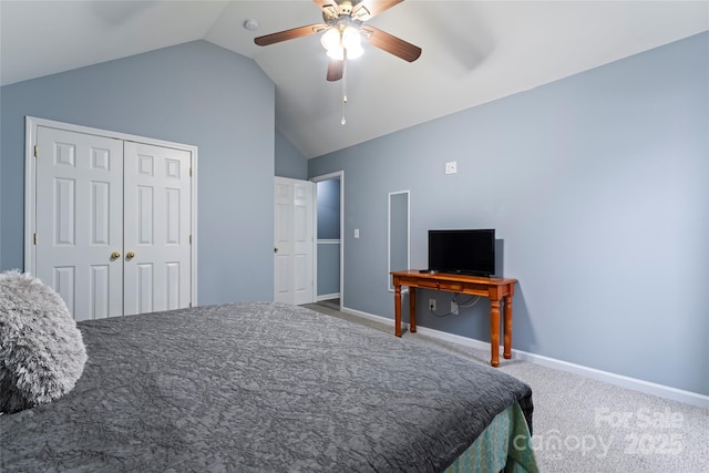 carpeted bedroom with ceiling fan, vaulted ceiling, and a closet