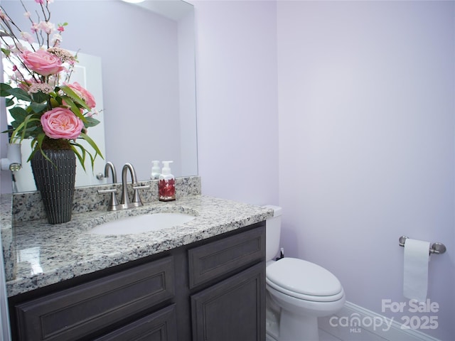 bathroom featuring toilet and vanity