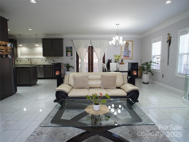 tiled living room with a chandelier, crown molding, and a wealth of natural light