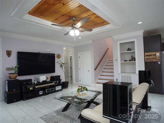 living room with built in shelves, wooden ceiling, ceiling fan, and ornamental molding