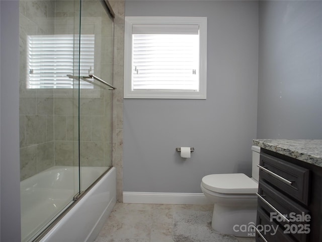 full bathroom with vanity, toilet, bath / shower combo with glass door, and tile patterned flooring