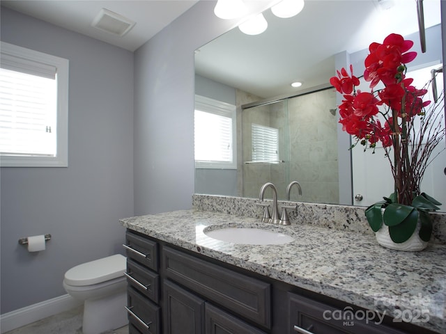 bathroom with toilet, walk in shower, and vanity