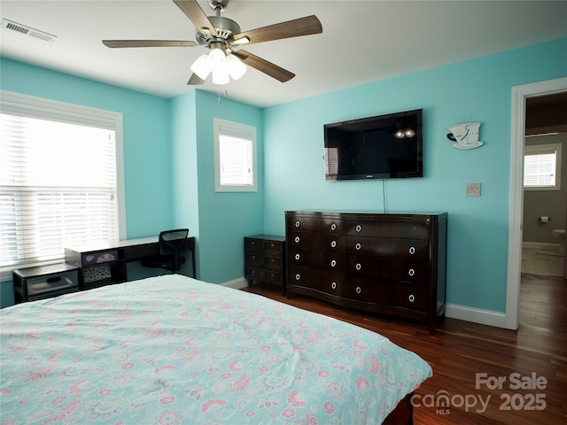 bedroom with dark hardwood / wood-style floors and ceiling fan