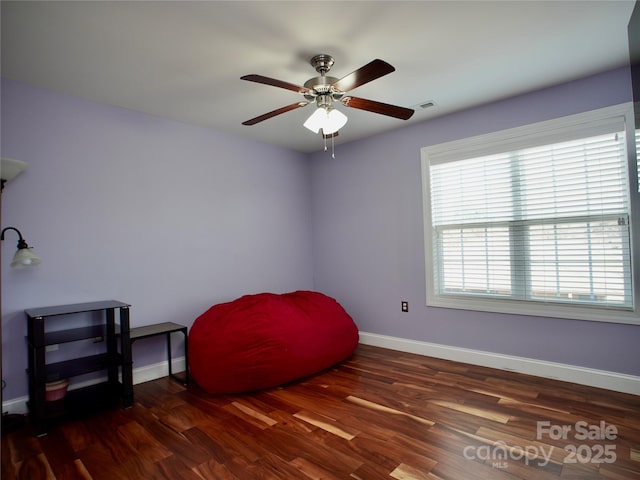 sitting room featuring ceiling fan and dark hardwood / wood-style flooring