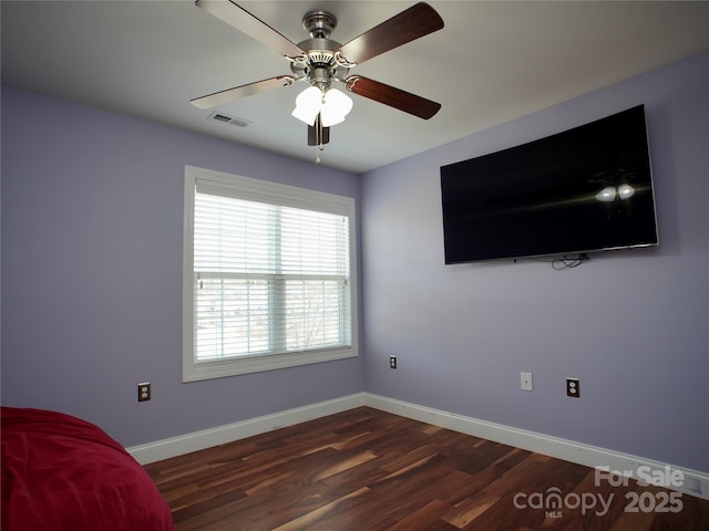 unfurnished bedroom featuring ceiling fan and dark hardwood / wood-style flooring