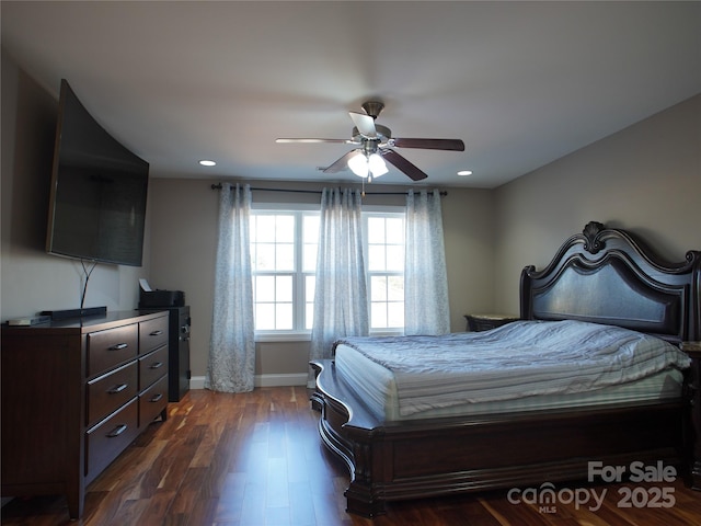 bedroom with ceiling fan and dark hardwood / wood-style flooring