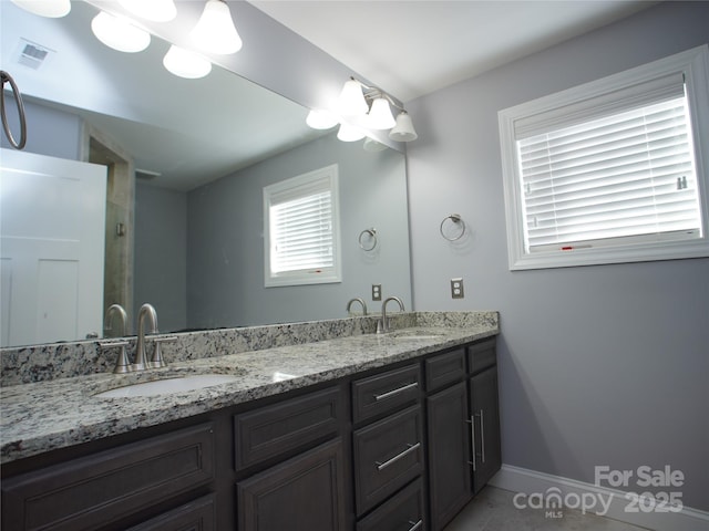 bathroom with vanity and tile patterned flooring