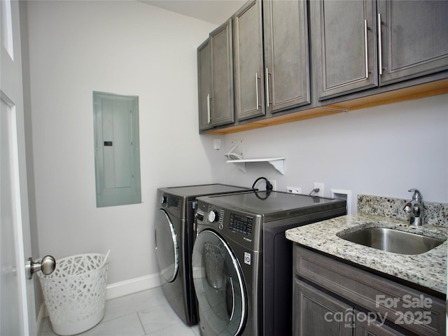 clothes washing area featuring sink, washer and dryer, electric panel, cabinets, and light tile patterned flooring