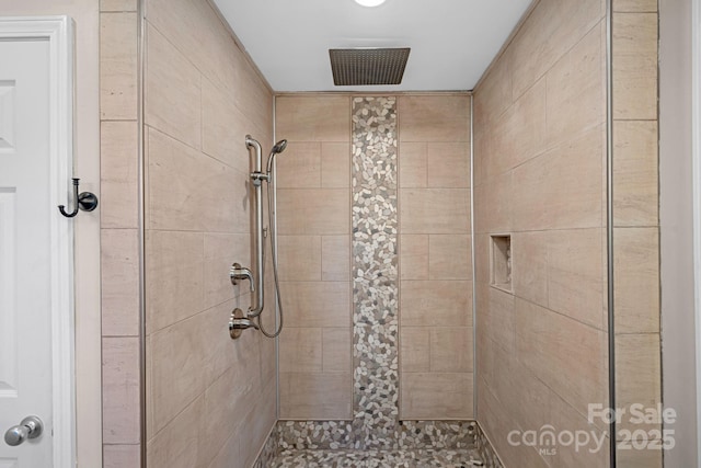 bathroom with tiled shower