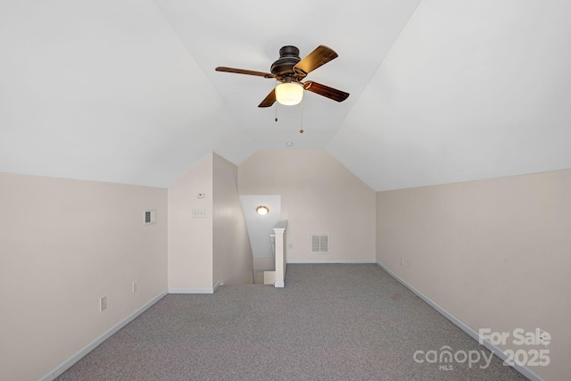 additional living space featuring light carpet, lofted ceiling, and ceiling fan