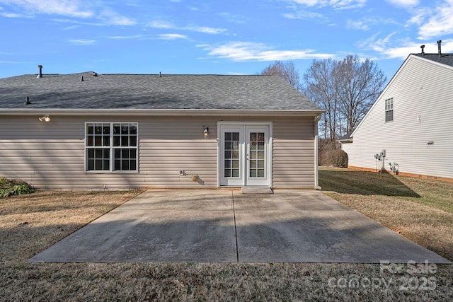 rear view of property with a yard, a patio area, and french doors