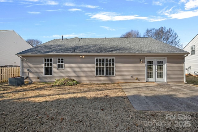 back of property featuring french doors, a yard, central AC unit, and a patio area