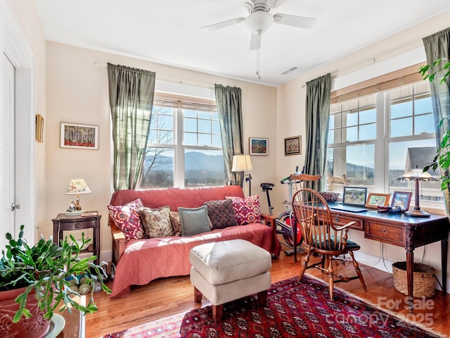 home office featuring hardwood / wood-style flooring and ceiling fan