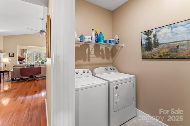 laundry area featuring ceiling fan, light hardwood / wood-style floors, and independent washer and dryer