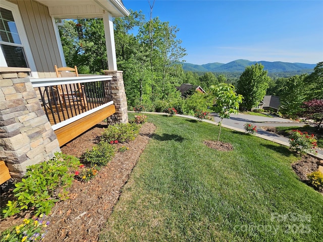 view of yard featuring a porch and a mountain view