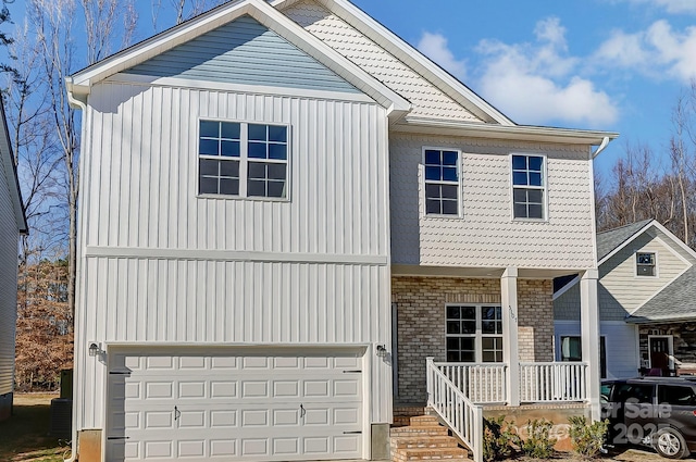 view of front property featuring covered porch and a garage