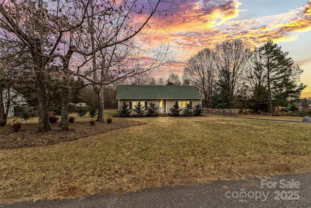 single story home featuring a yard