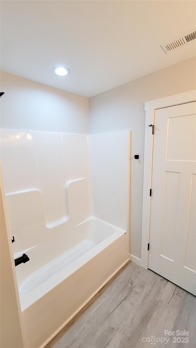 full bathroom with  shower combination, wood finished floors, visible vents, and recessed lighting