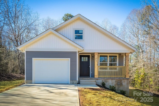 view of front of home featuring a garage, driveway, and a porch