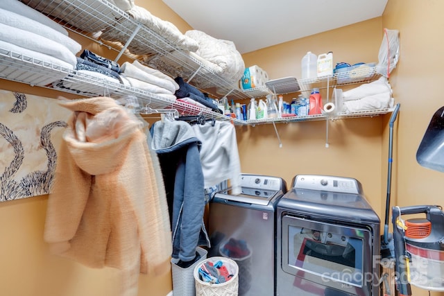 clothes washing area with washing machine and dryer