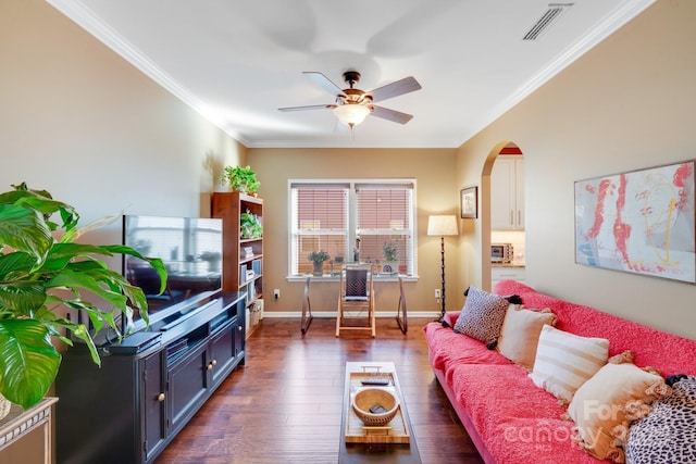 living room with dark hardwood / wood-style flooring, crown molding, and ceiling fan