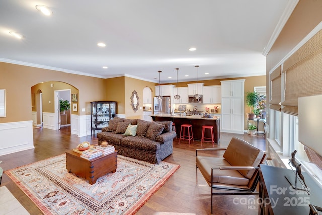 living room with crown molding and hardwood / wood-style floors