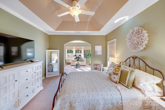 bedroom with ornamental molding, a raised ceiling, ceiling fan with notable chandelier, and light carpet