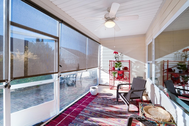 sunroom with a healthy amount of sunlight and ceiling fan