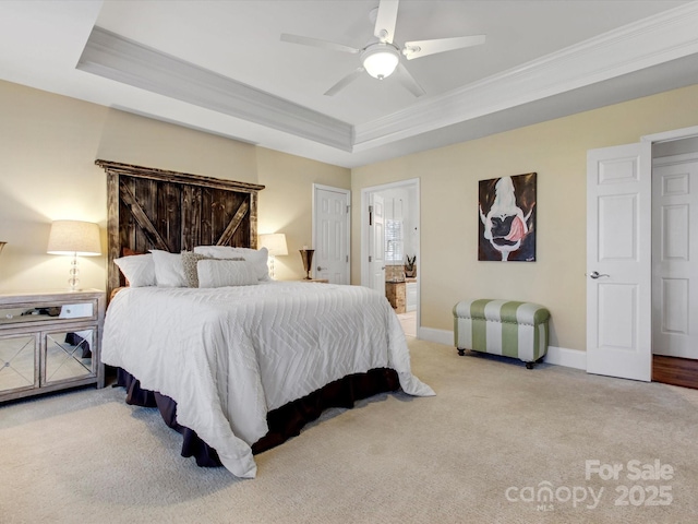 bedroom with ceiling fan, a tray ceiling, ornamental molding, and light carpet