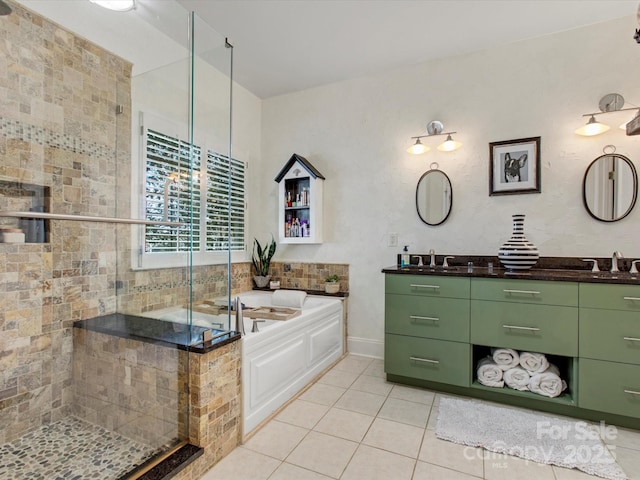 bathroom featuring tile patterned flooring, vanity, and shower with separate bathtub