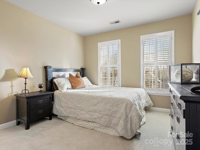 carpeted bedroom featuring multiple windows