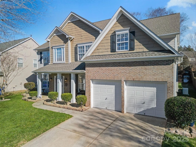 view of front facade featuring a porch, a garage, and a front yard