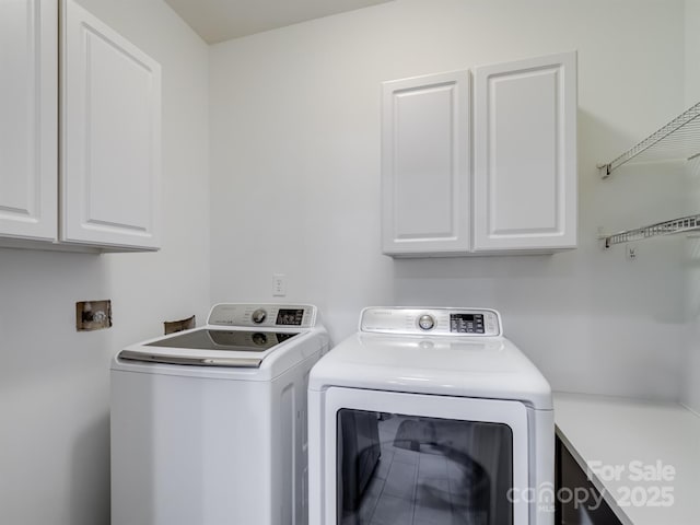 laundry area with cabinets and washing machine and clothes dryer