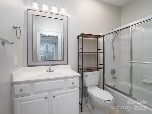 full bath with toilet, vanity, and shower / bath combination with glass door