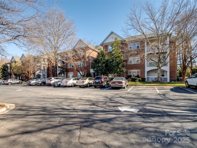 exterior space featuring uncovered parking and a residential view