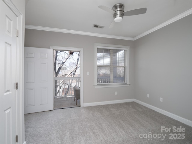 carpeted empty room featuring ceiling fan and ornamental molding