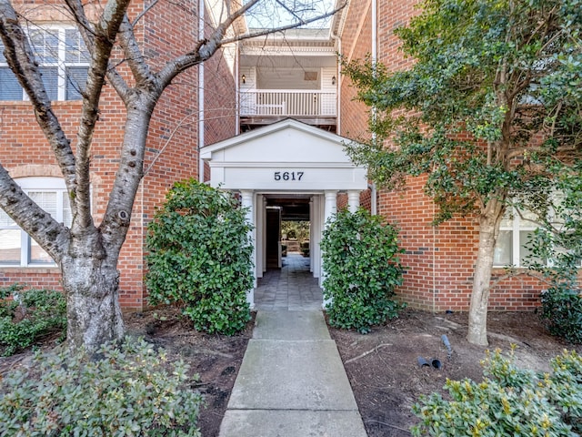 view of exterior entry with brick siding