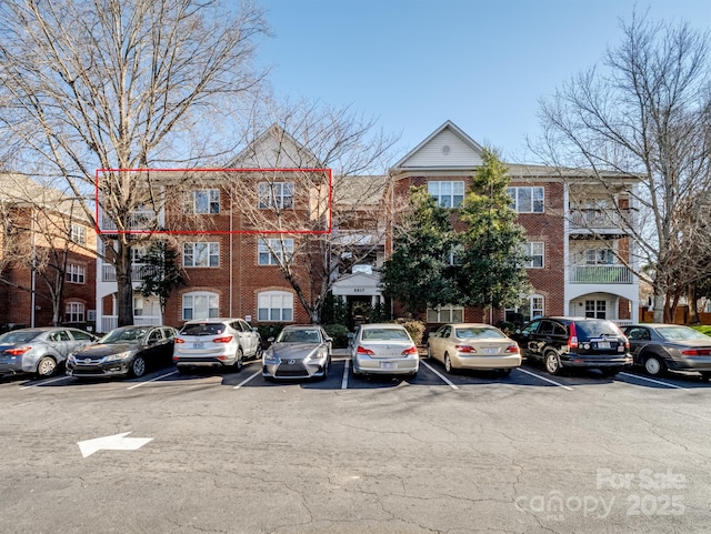 view of property featuring uncovered parking