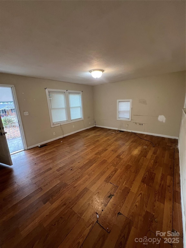 empty room featuring wood-type flooring