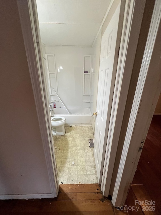 bathroom featuring shower / washtub combination and toilet