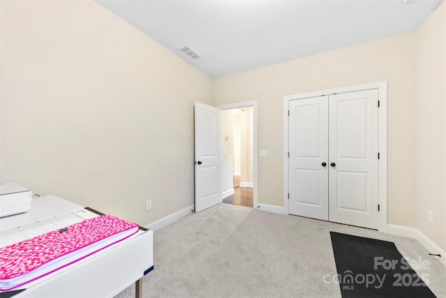 bedroom featuring carpet, a closet, visible vents, and baseboards