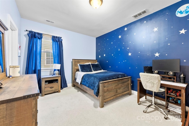 carpeted bedroom featuring an accent wall, visible vents, baseboards, and wallpapered walls