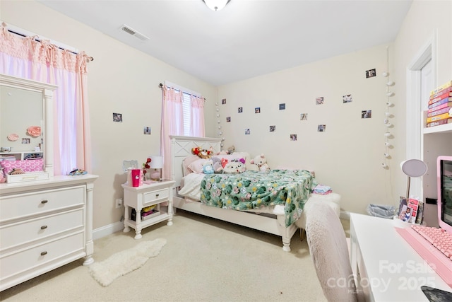 bedroom featuring visible vents, light carpet, and baseboards