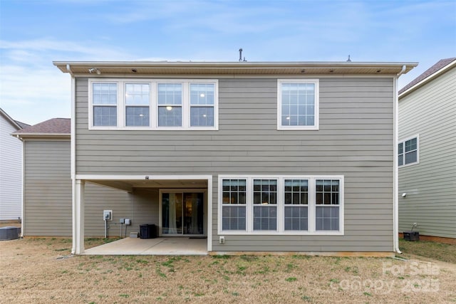 rear view of house with central air condition unit and a patio area