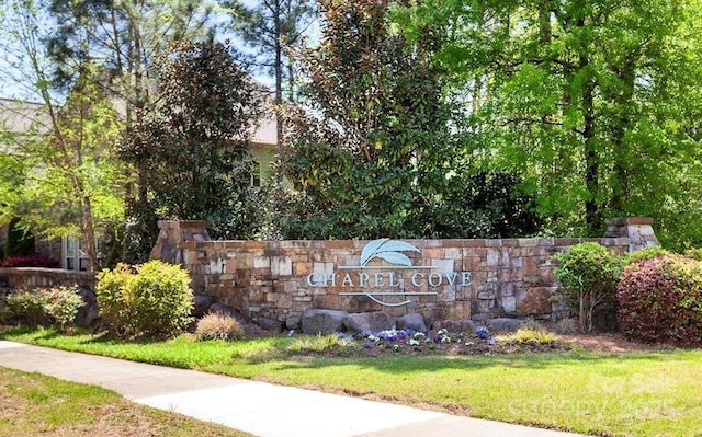 community / neighborhood sign with a yard