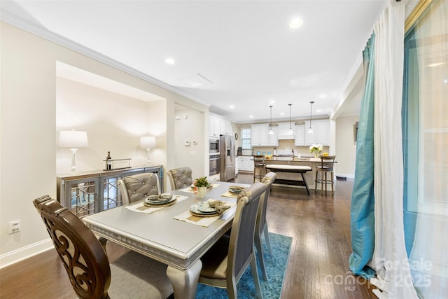 dining space featuring ornamental molding, dark wood-type flooring, baseboards, and recessed lighting